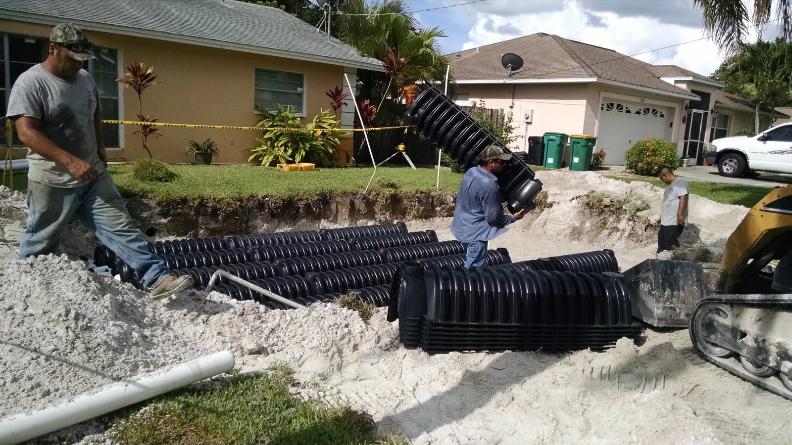 The crew installing a drain field at a home